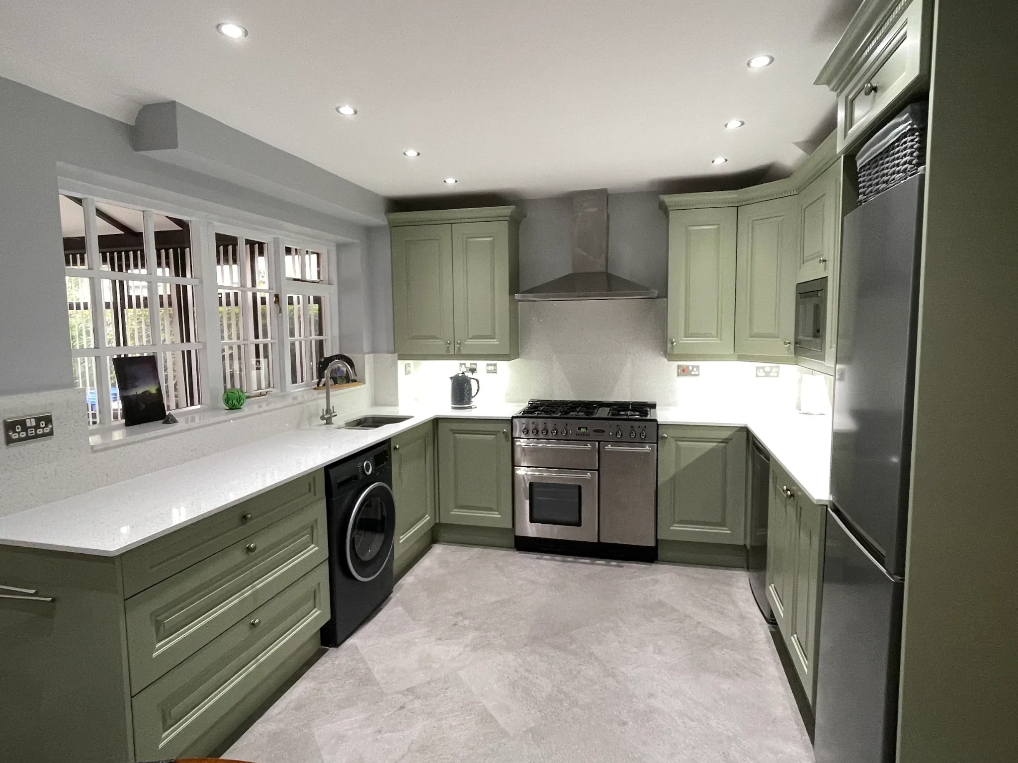 Sheila's kitchen after — resprayed doors, bespoke oak units and quartz worktops